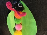 Children's craft: A paper leaf with a pom pom caterpillar
