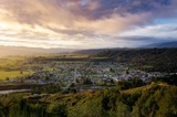 Arial photo of a small country town at sunset amongst the mountains