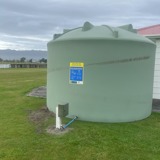 Water storage tank installed on a green field