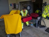 Airport staff loading luggage in trolley